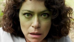 Jenn Walters begins to turn green as she transforms into the Hulk.